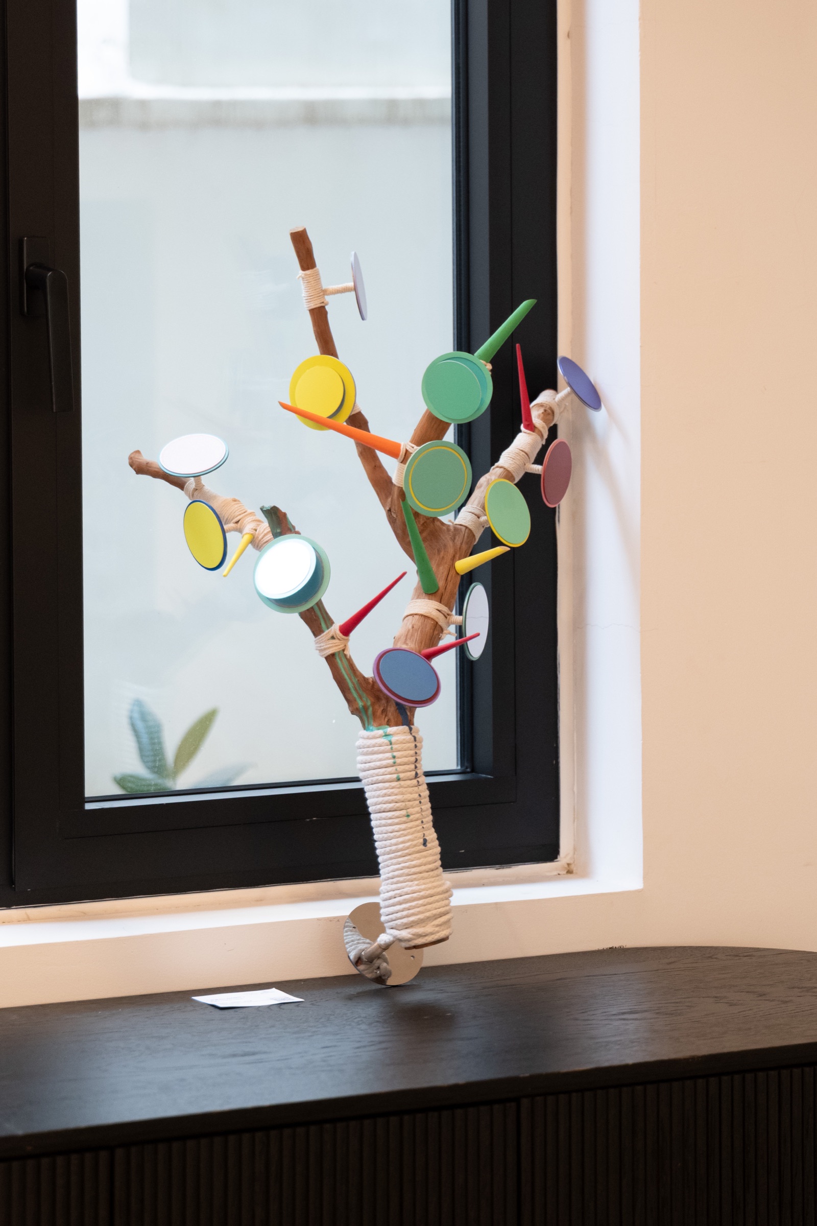 Colourful sculptural artwork by a gallery window